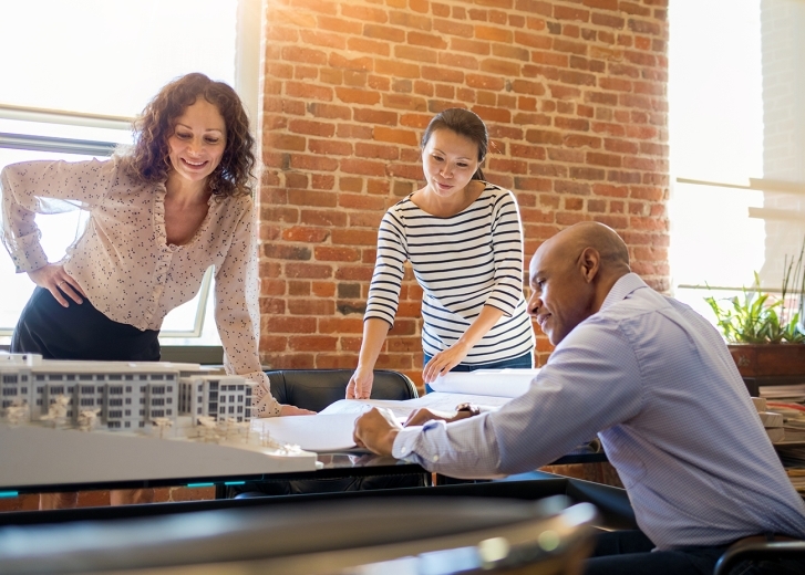 business owner looking over architectural plans